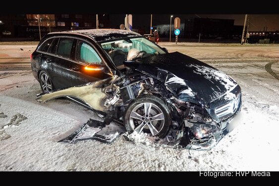 Automobilist ramt paal op besneeuwd wegdek bij Avenhorn